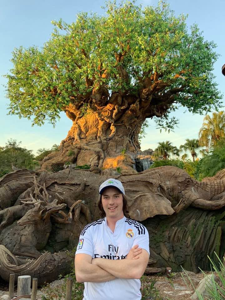 Son Kyle Skowron wearing his Morning Star Tree Co. cap in front of the Tree of Life